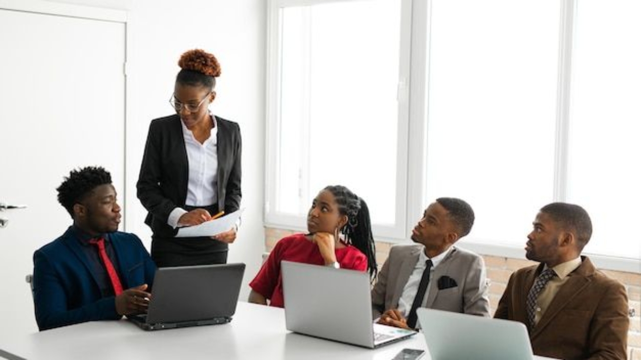 Team of young african people in the office at the table with a laptop _ Premium Photo