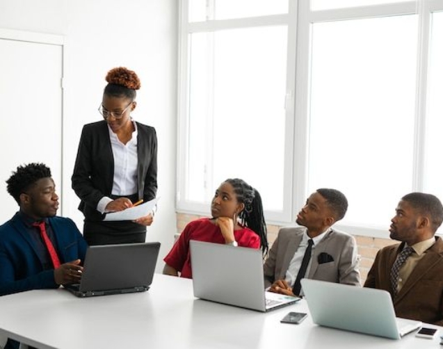 Team of young african people in the office at the table with a laptop _ Premium Photo